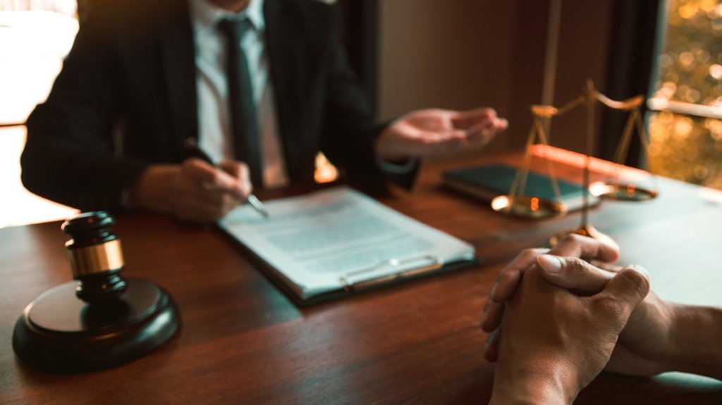 Lawyer is providing information about the client’s trial at the lawyer office_s Lawyer is providing information about the client's trial at the lawyer office