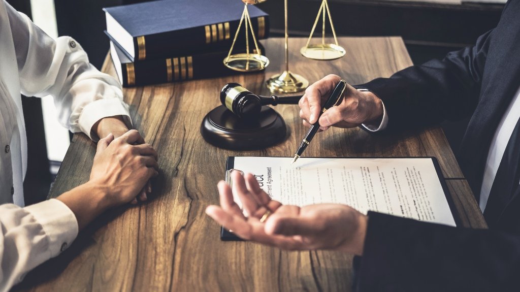 Slip And Fall Lawyer Reviewing Injury Claim With Client Slip And Fall Lawyer Reviewing Injury Claim With Client