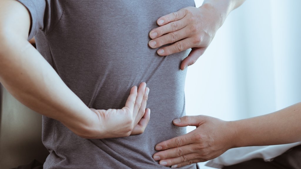 Doctor examines back pain after Slip and Fall accident_s Doctor examines back pain after Slip and Fall accident