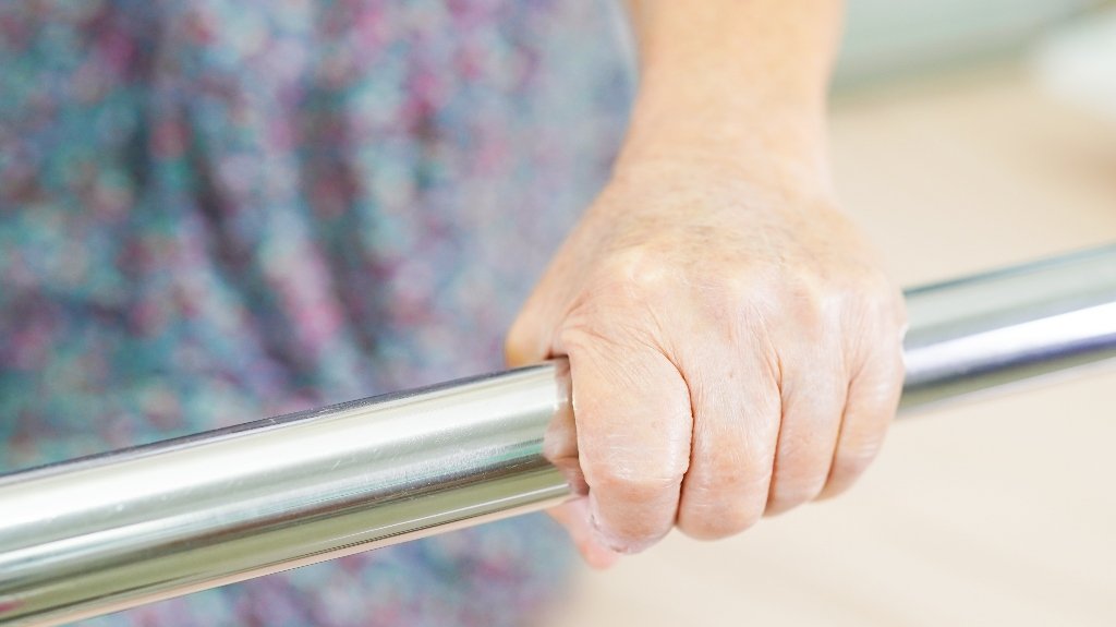 senior woman patient holding bed rail_s senior woman patient holding bed rail